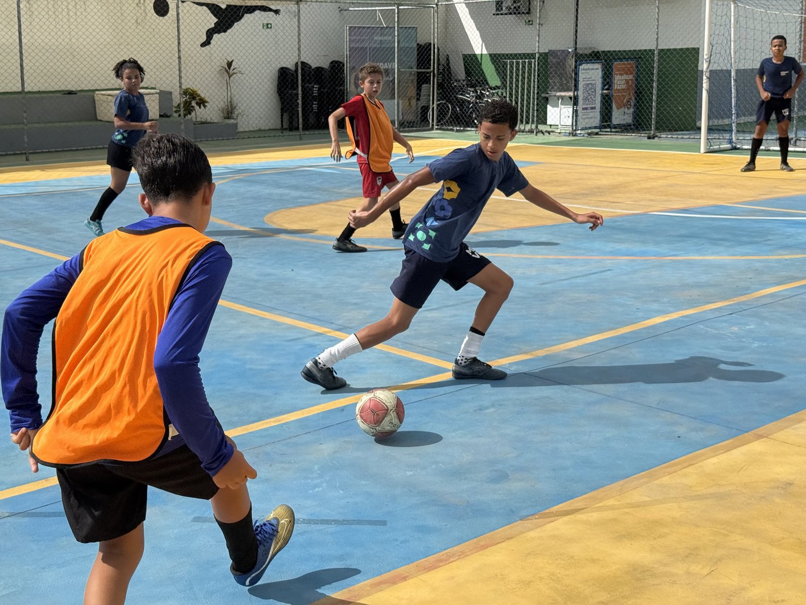 Grassroots athletes playing a futsal match at the workshop